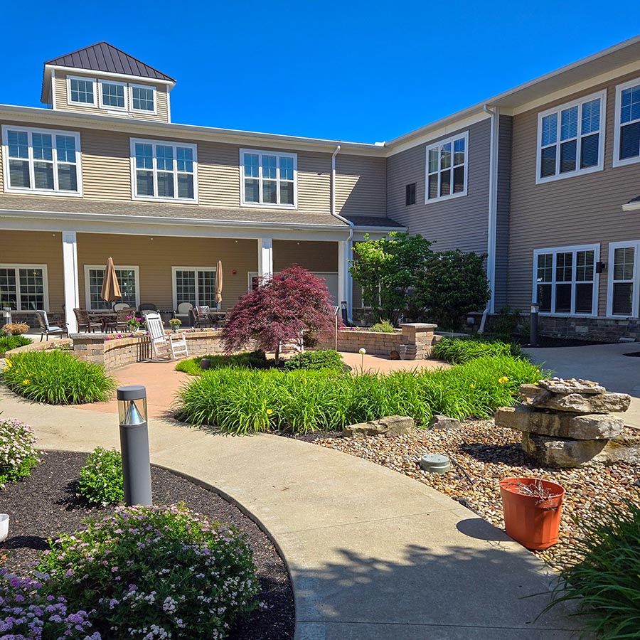 A courtyard with landscaping and a fountain in front of Vitalia Westlake.