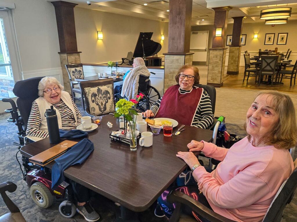 Three senior ladies enjoying dining at the Vitalia Westlake senior living restaurant.