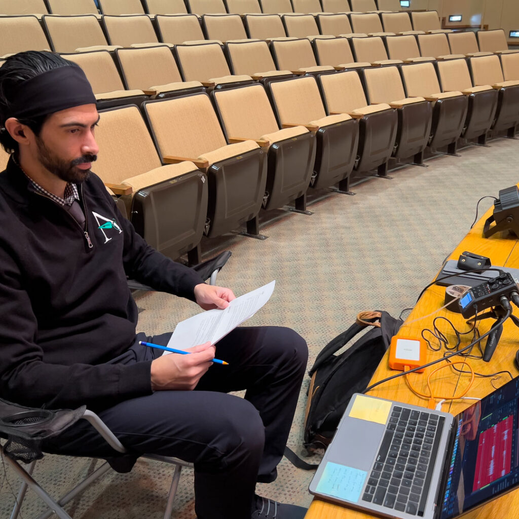 Lenny Hernandez, Regional Project Coordinator for New Development at Arrow Senior Living, prepares audio equipment for a live Thoughtful Connections memory care podcast recording.