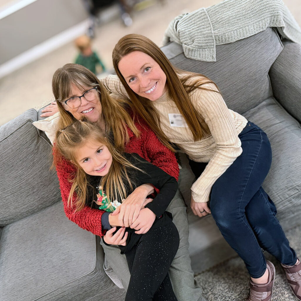 A resident smiles alongside family during a relaxed moment at Vitalia Westlake.
